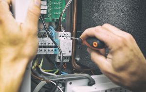 image of a man installing electrical equipment