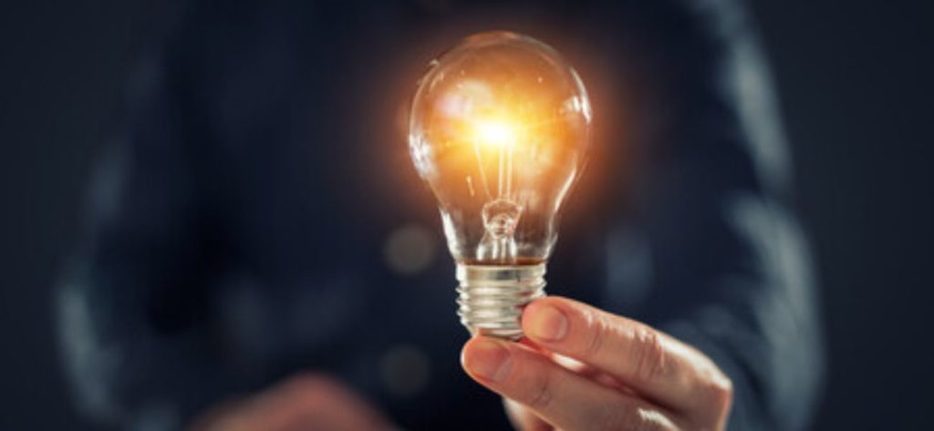 close up image of someone holding a lightbulb