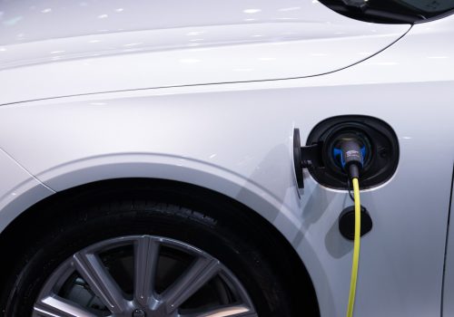 image of an EV charger plugged into a car
